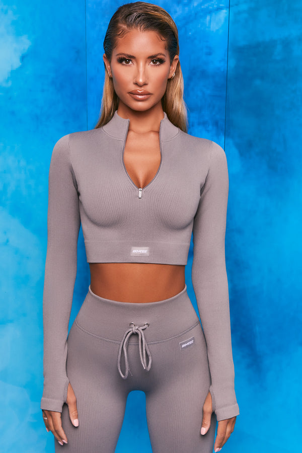 Plain grey ribbed high neck crop top with zip front and long sleeves. Image 1 of 6
