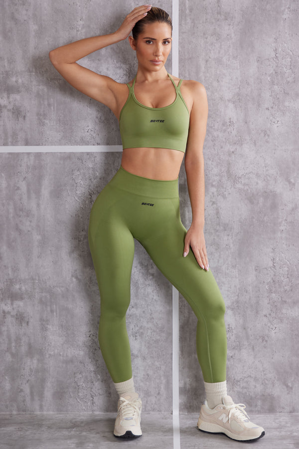 model wearing matching olive gym leggings and sports bra set