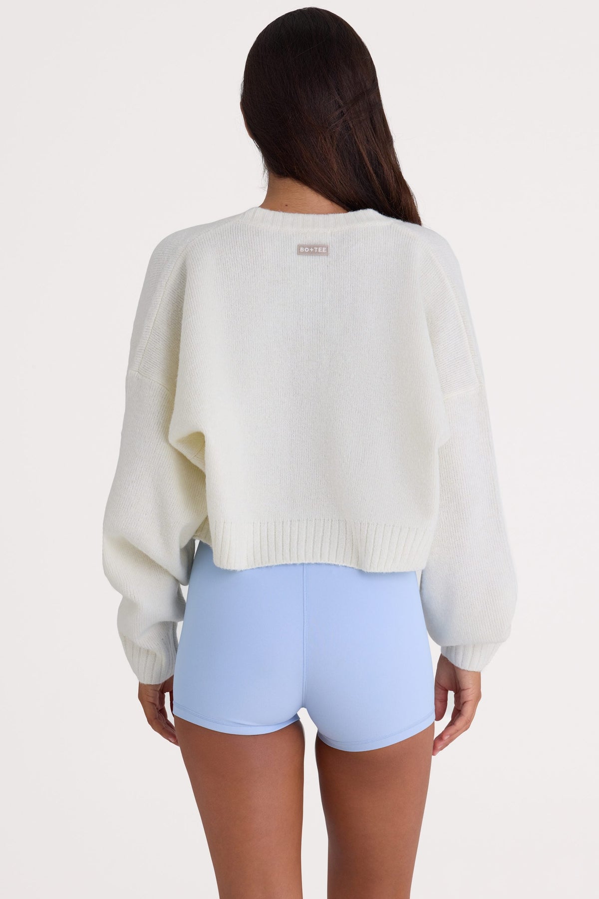 Bo+Tee model Nikki wearing the Christmas Knits Cardigan in Ivory Knitwear fabric perfect for festive gatherings