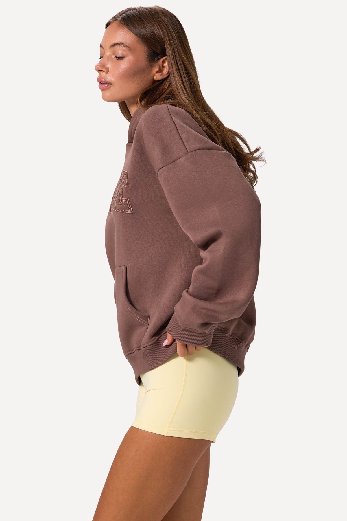 Bo+Tee model Lydia Butler wearing the CosyCoffeeRunWithLydsButler Hoodie in Cocoa Brushback sweat fabric perfect for casual weekend strolls