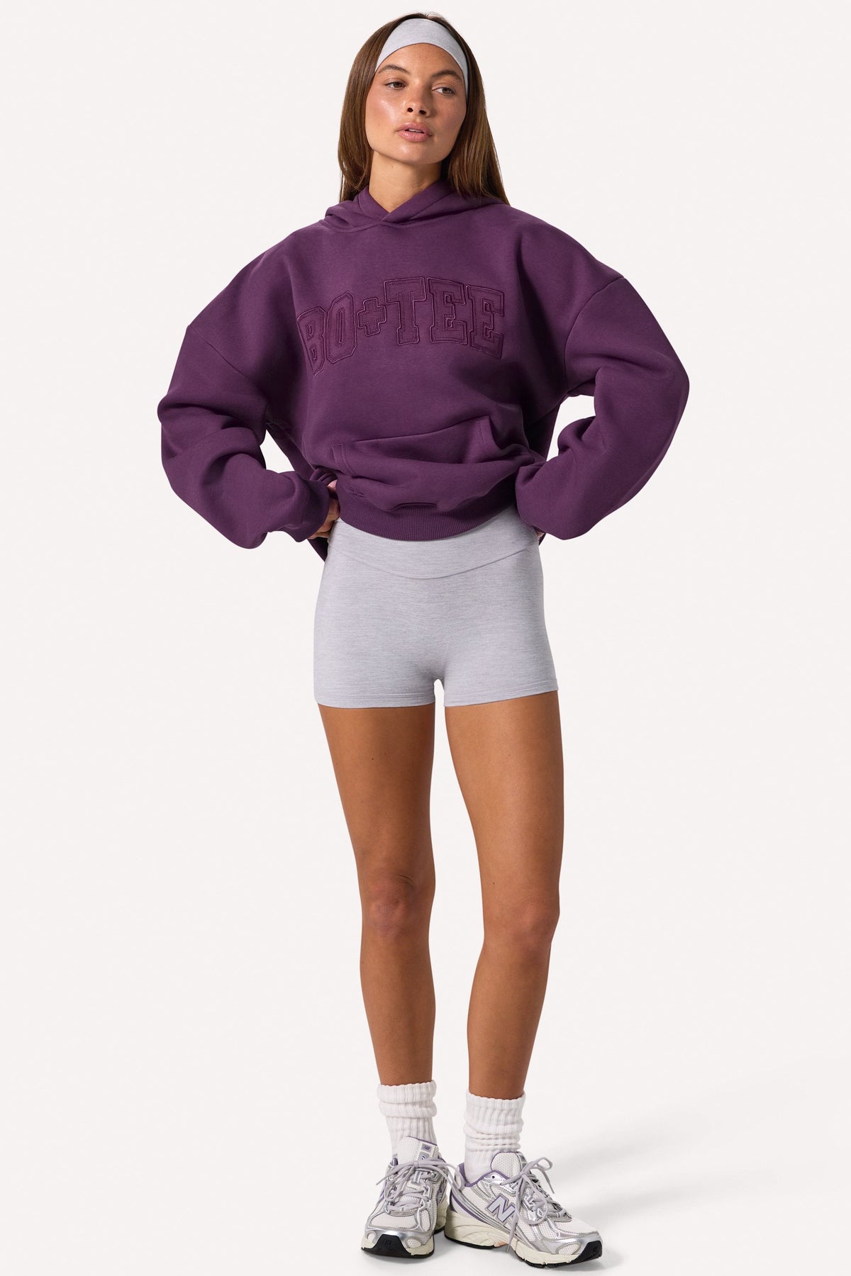 Bo+Tee model Lydia Butler wearing the CosyCoffeeRunWithLydsButler Hoodie in Plum Brushback sweat fabric perfect for morning coffee runs