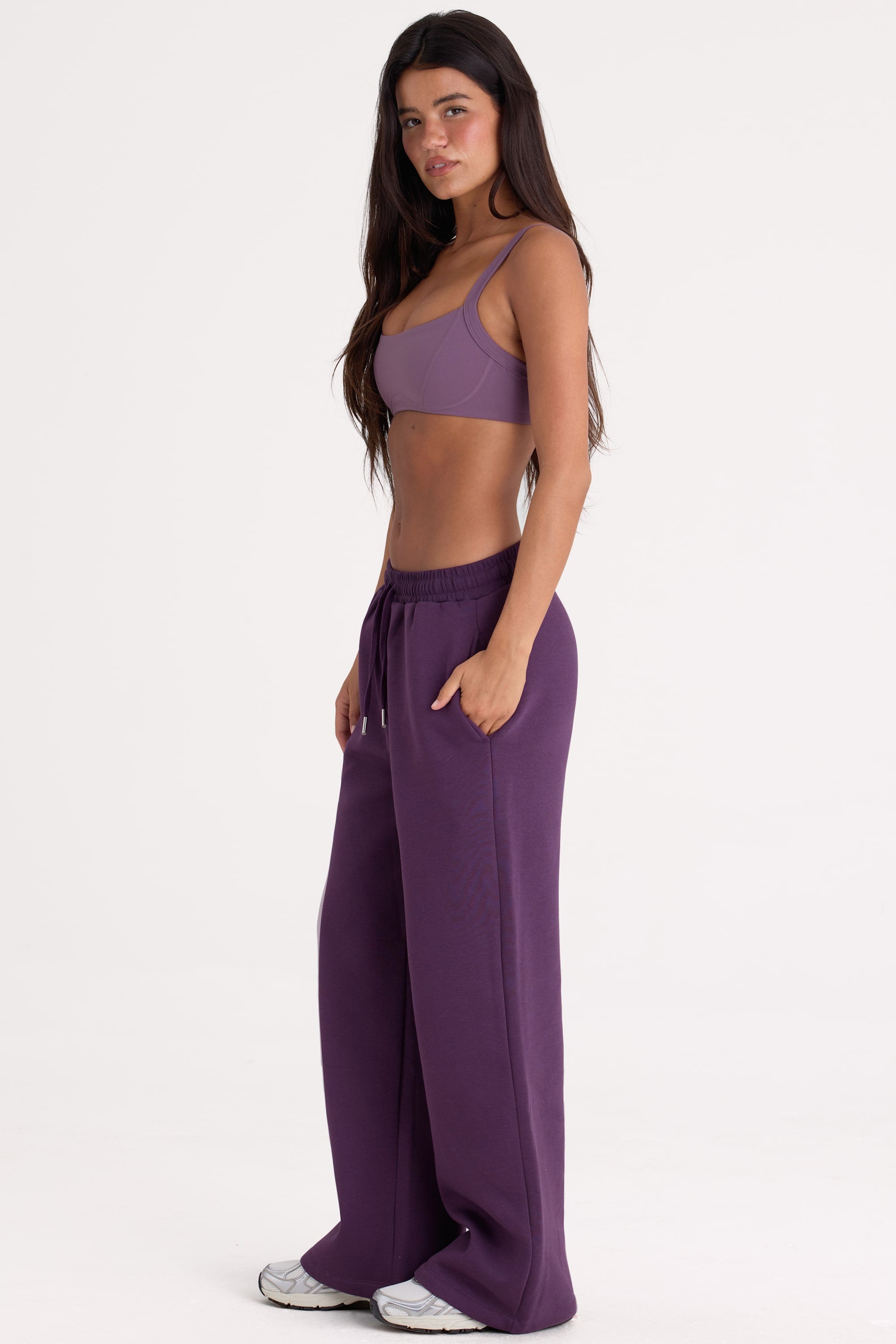 Bo+Tee model Lydia Butler wearing the CosyCoffeeRunWithLydsButler Joggers in Plum Brushback sweat fabric perfect for casual weekend strolls