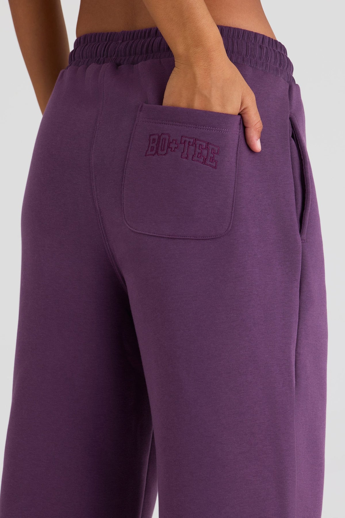 Bo+Tee model Lydia Butler wearing the CosyCoffeeRunWithLydsButler Joggers in Plum Brushback sweat fabric perfect for running errands comfortably