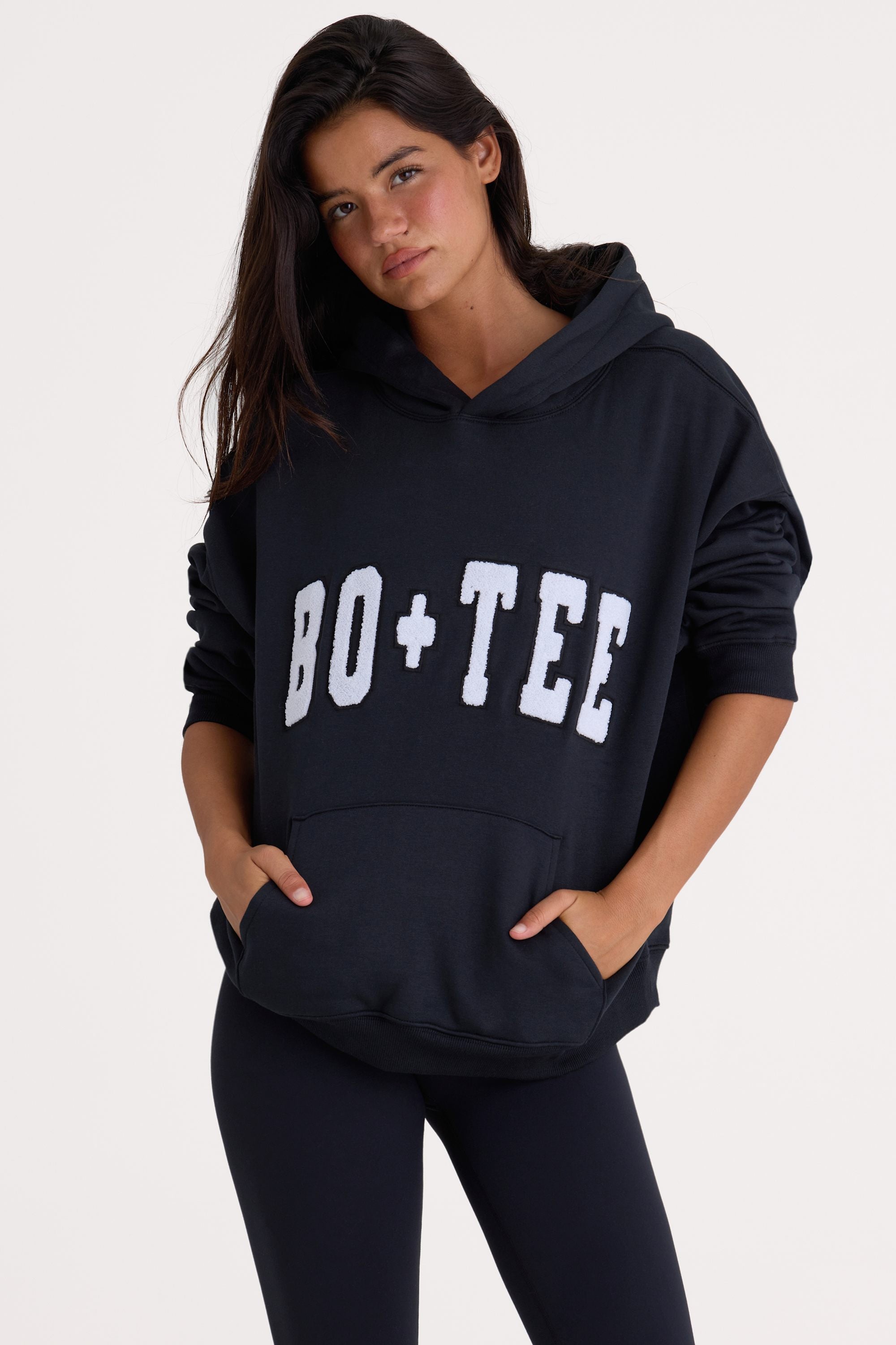 Bo+Tee model Cristal wearing the Off-Duty Hoodie in Black Cotton fabric perfect for weekend errands