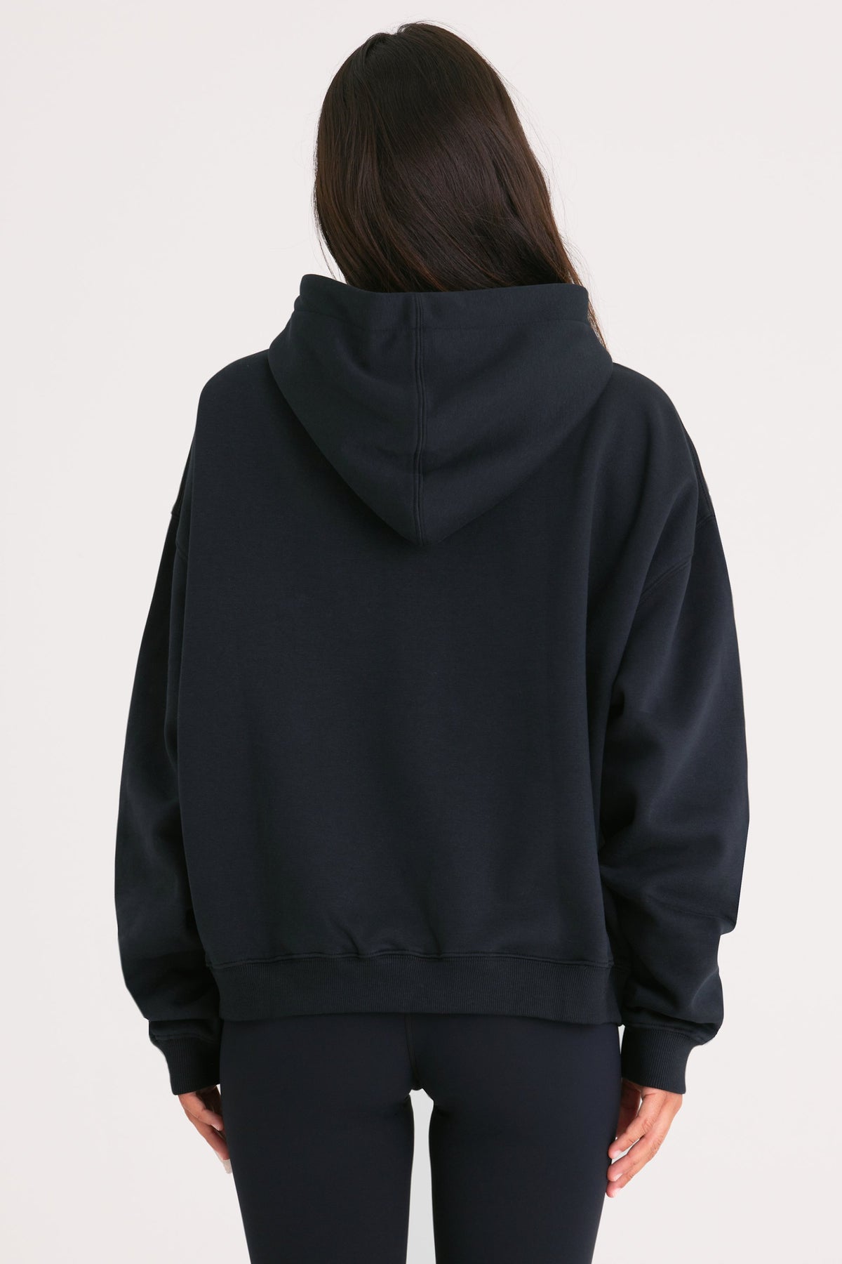 Bo+Tee model Cristal wearing the Off-Duty Hoodie in Black Cotton fabric perfect for weekend errands