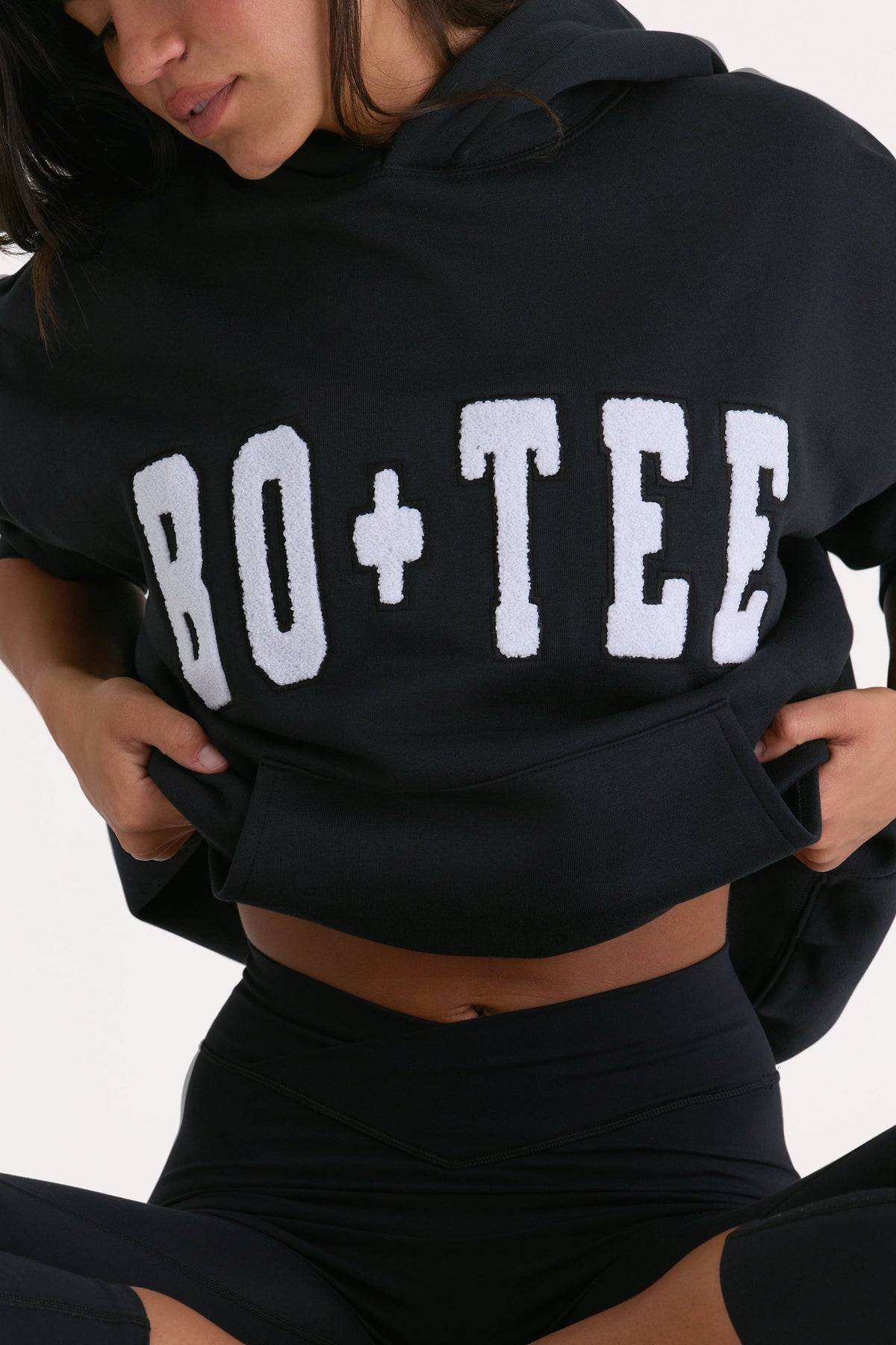 Bo+Tee model Kiele wearing the Off-Duty Hoodie in Black Cotton fabric perfect for coffee runs