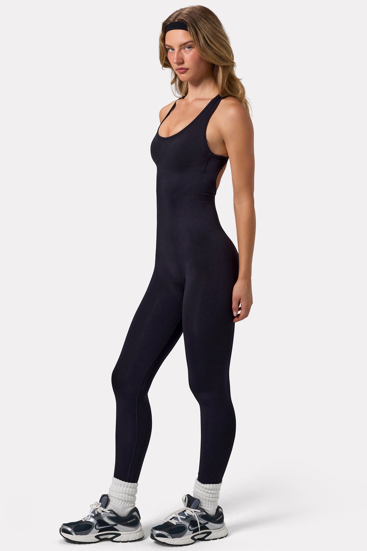 Bo+Tee model Virginia Sanhouse wearing the Silhouette Jumpsuit (reg) in Black Define Luxe (Seamless) fabric perfect for yoga sessions