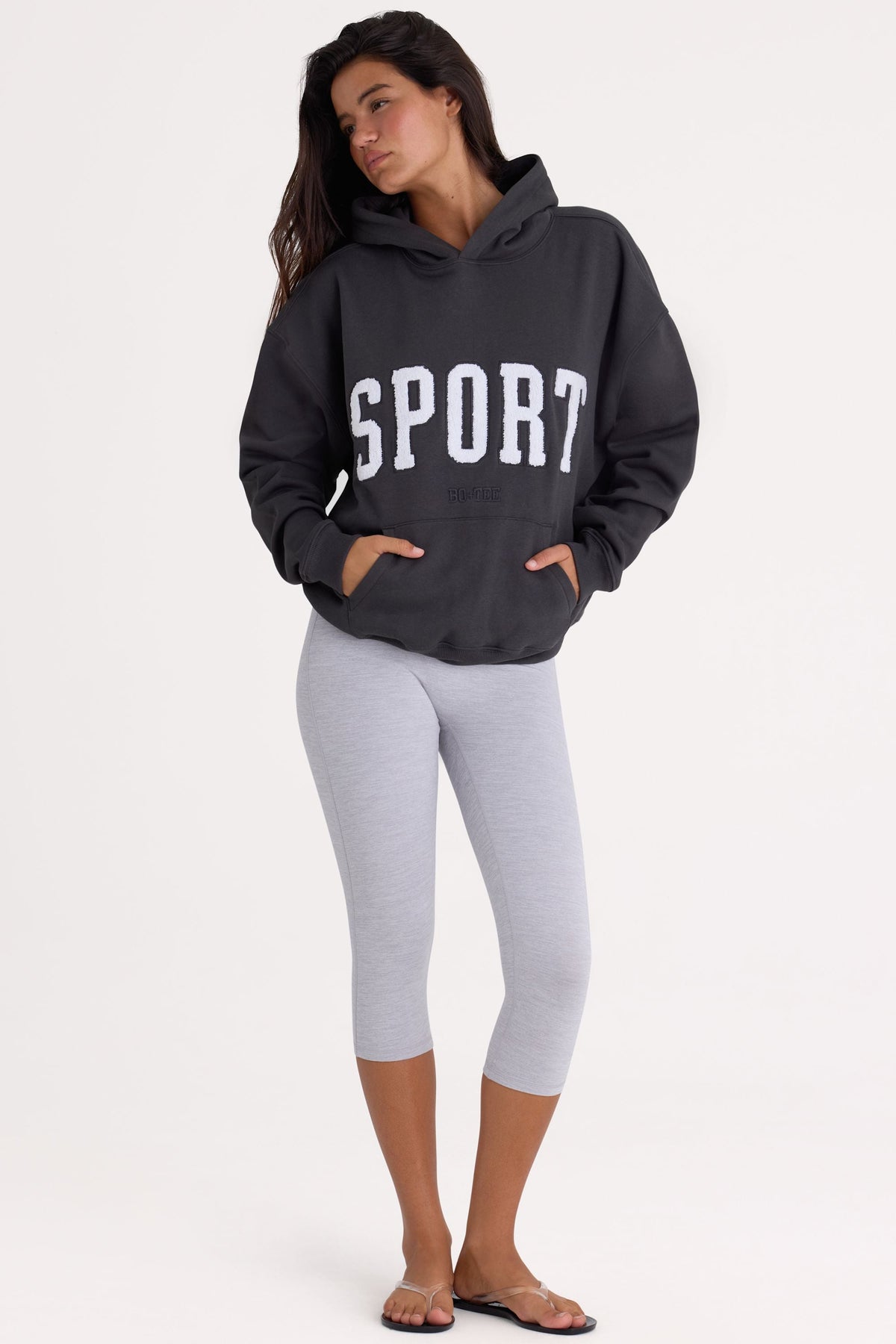Bo+Tee model Kiele wearing the Varsity Hoodie in Black Cotton fabric perfect for gym workouts