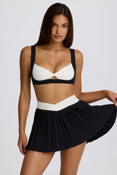 Soft Active Crossover Pleated Mini Skort in Black