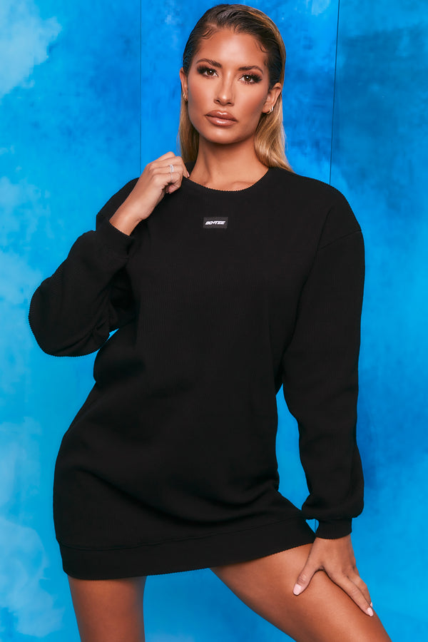 Plain black ribbed oversized sweatshirt with long sleeves. Image 1 of 6.