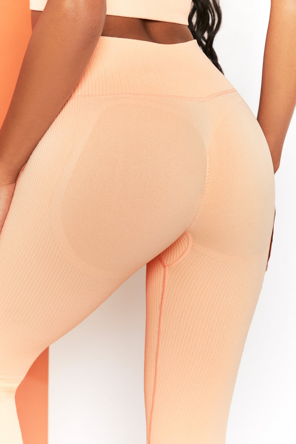 close up of back detail on peach gym leggings