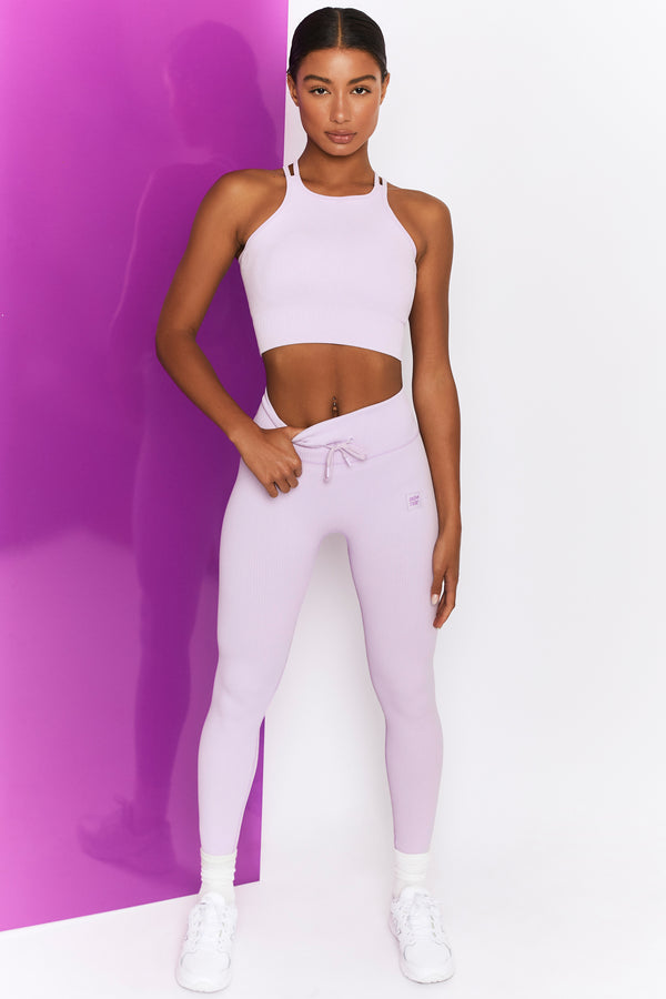 image of model in tie front lilac gym leggings and matching crop top