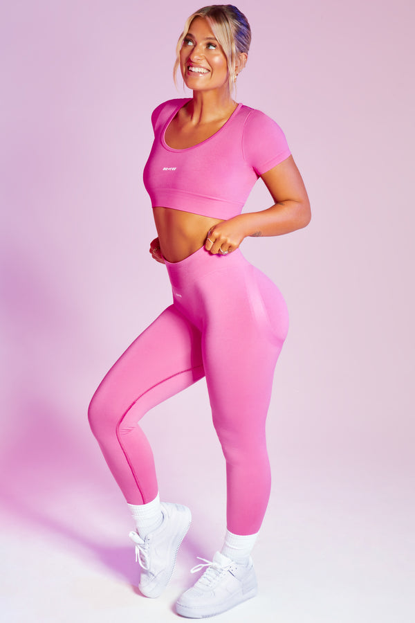 pink womens gym leggings styled with seamless gym crop top