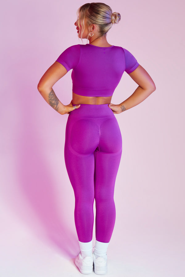 back of high waisted seamless womens gym leggings and crop top in purple