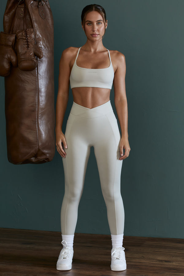 model wearing matching petite leggings and crop top in grey