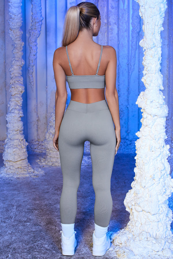 back view of model wearing grey womens gym leggings and crop top