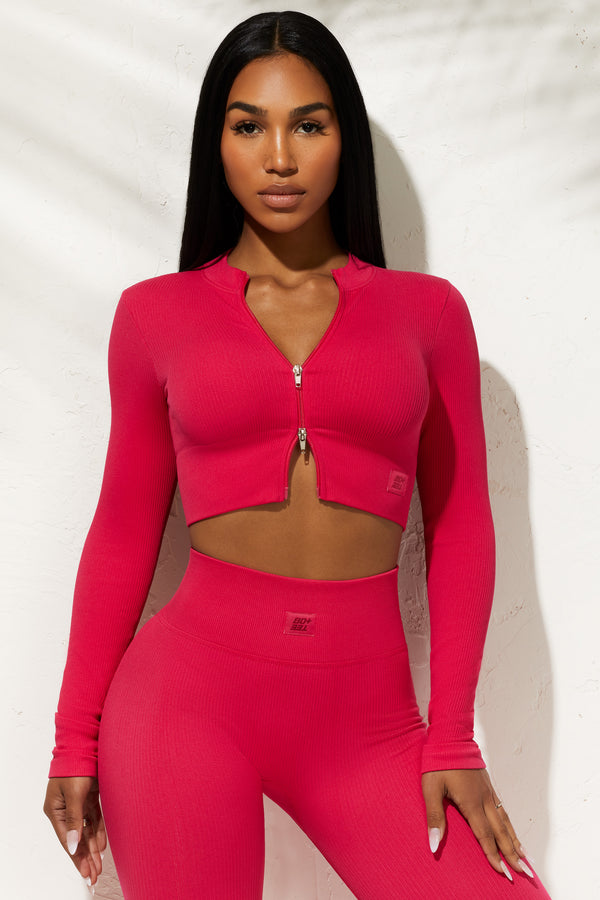 model wearing zip up hot pink crop top and matching leggings